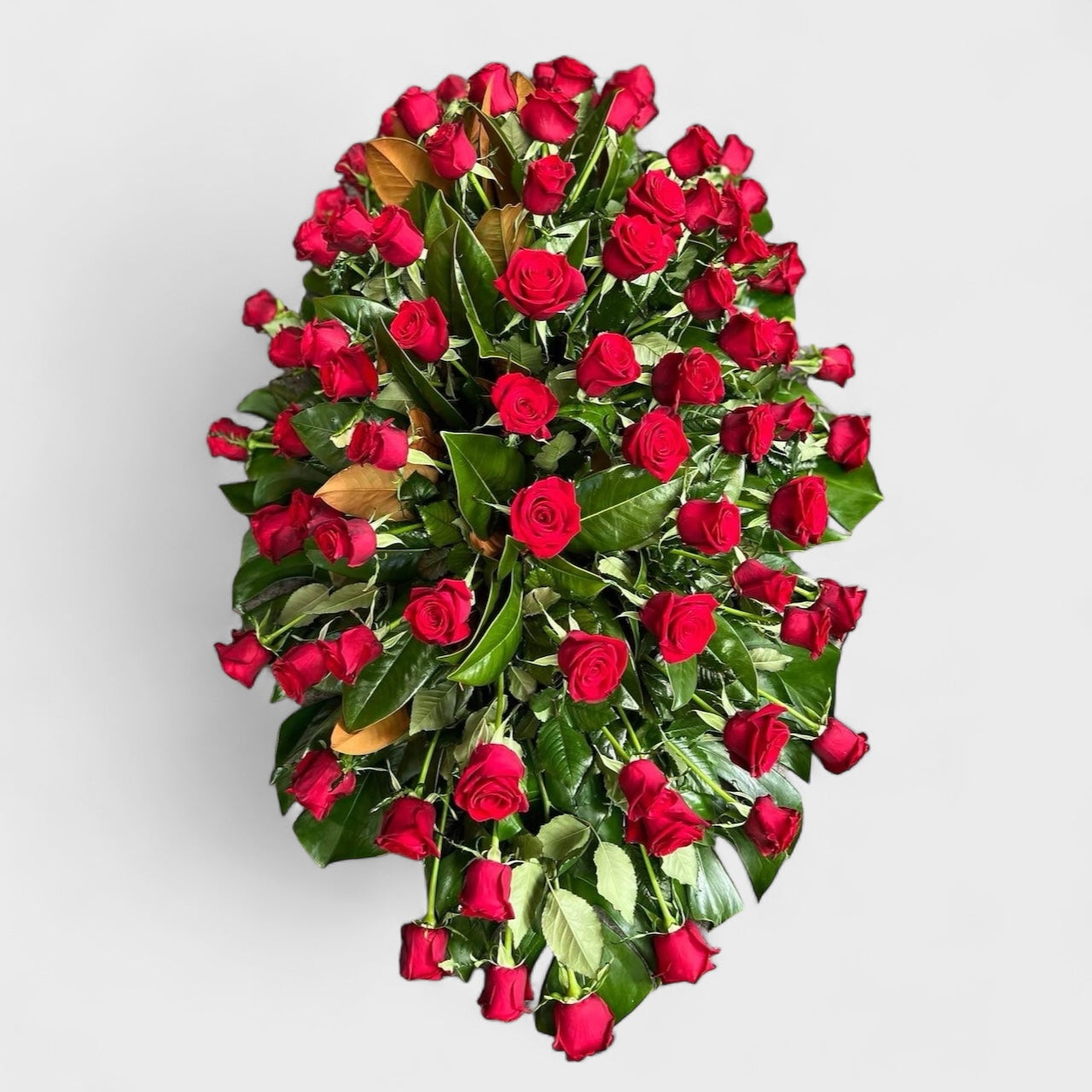 Kingsley casket spray with white lilies – Auckland funeral flowers by Tomuri & Co.