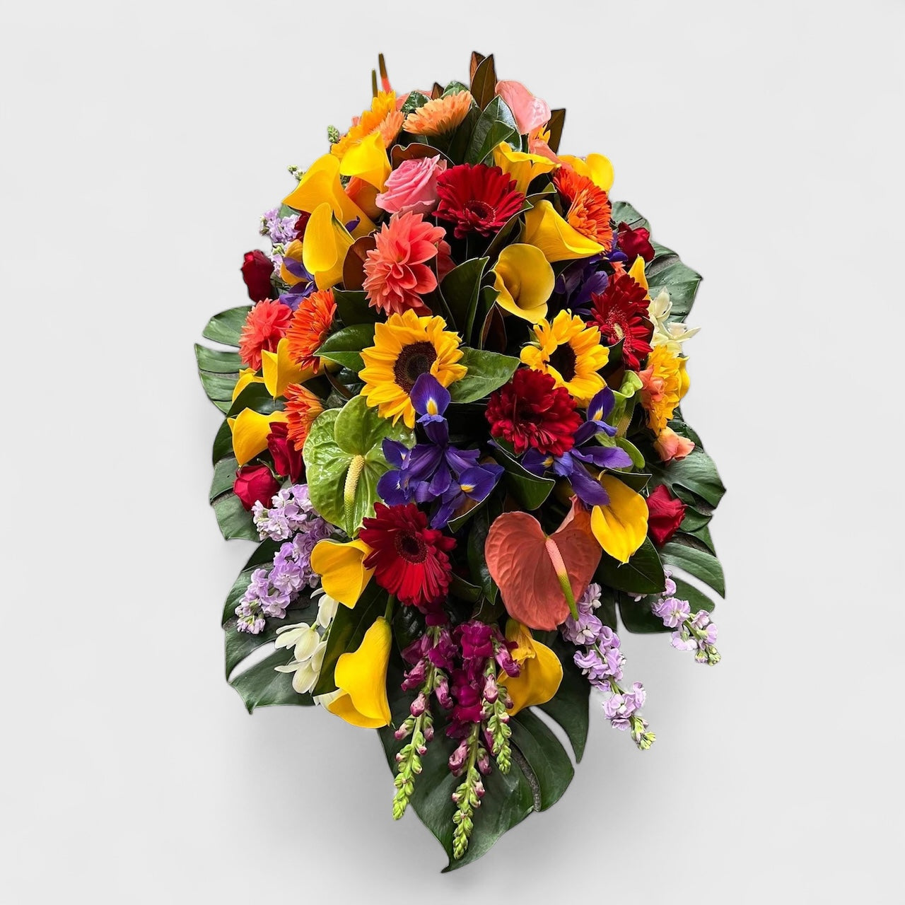 Livingstone casket spray with white and green blooms – Auckland funeral flowers by Tomuri & Co.